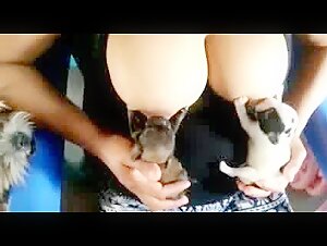 Woman Breastfeeding a Puppy