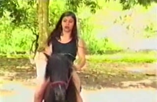 She yields, brunette and submissive beneath the stallion's power